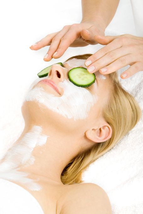 Picture promoting self-care, a person relaxing with a face mask and cucumber on their eyes